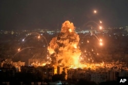 Flames and smoke rise from an Israeli air strike in the Dahieh area of Beirut on October 6.