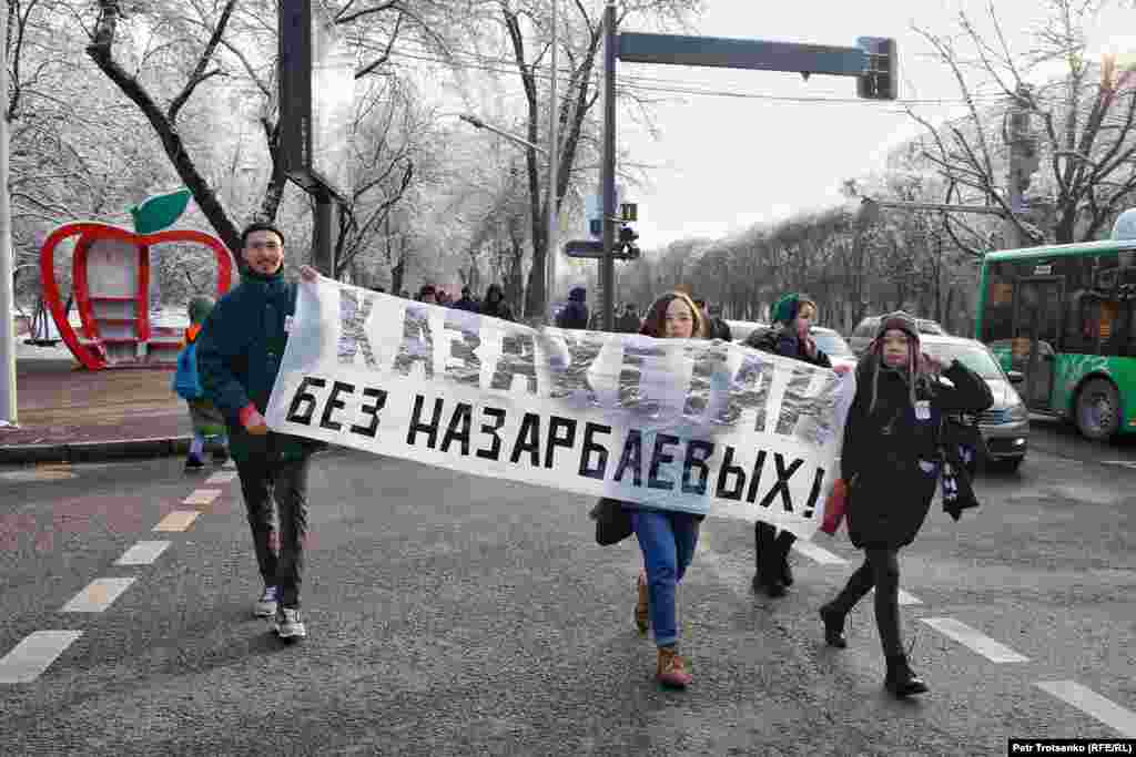 Protesters in Almaty hold a sign saying, &quot;Kazakhstan Without The Nazarbaevs.&quot; Former President Nursultan Nazarbaev resigned in March but is still a powerful figure behind the scenes.