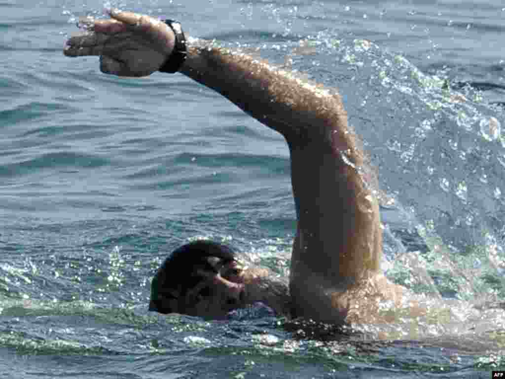 Georgian President Mikheil Saakashvili swims in the Black Sea on October 20 near the resort city of Batumi. According to Georgian media reports, Saakashvili swam about three kilometers in a bid to prove that the holiday season in Batumi lasts six months. Photo by Irakli Gedenidze for AFP