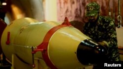 A member of the Iranian Revolutionary Guards checks a missile inside an underground depot in an undisclosed location, in this handout photo released by the official website of IRGC on March 8, 2016