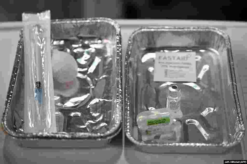 Флакон с вакциной и свежий шприц &ndash; одно из устройств, которые можно увидеть на лотках в госпитале Луизы Джордан в Глазго 8 декабря 2020 года, когда начали вводить вакцину Pfizer/BioNTech COVID-19 в крупнейшей в Великобритании программе вакцинации