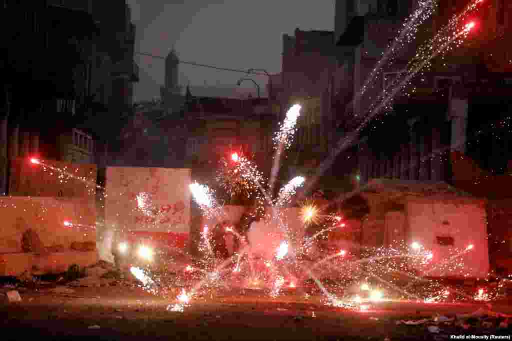 Iraqi demonstrators throw fireworks toward security forces during ongoing anti-government protests in Baghdad. (Reuters/Khalid al-Mousily)