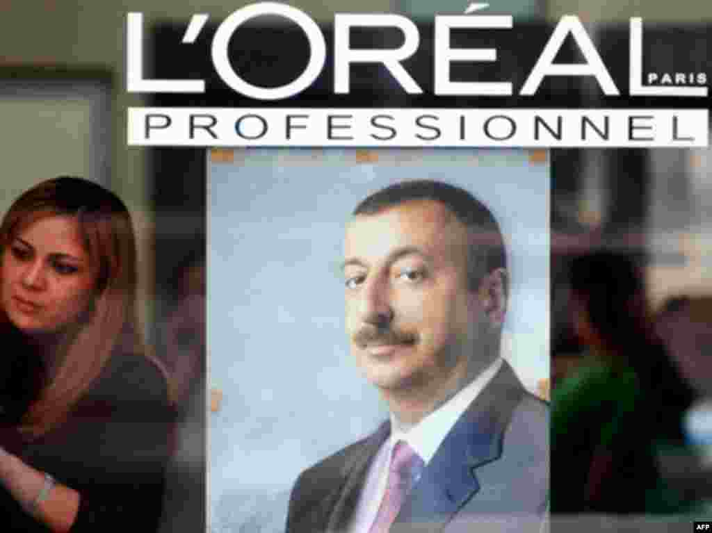 AZERBAIJAN, Baku : An elections poster for incumbent Azeri President Ilham Aliyev hangs in shop window in Baku on October 14, 2008. Aliyev is likely to sweep re-election on October 15 for a second term as the leader of Azerbaijan, located in the turbulent Caucasus mountain zone.