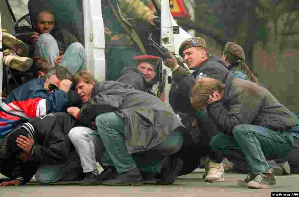 In an iconic picture that captures the opening moments of the siege, a Bosnian soldier takes aim to return fire after Serb gunmen shot into a crowd of peace demonstrators on April 6, 1992.