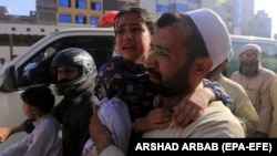 Children who complained of health issues after being administered polio vaccines are rushed to a hospital for treatment in Peshawar, Pakistan, on April 22.