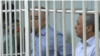 Omurbek Tekebaev (left) and Duishonkul Chotonov appear in court on June 5.