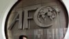 (FILES) This file photo taken on October 10, 2001 shows a worker putting the finishing touches to the new logo of the Asian Football Confederation (AFC) at their headquarters in Kuala Lumpur.