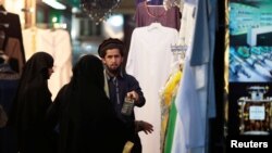 Women shop for clothing at Murshid Bazar, the Iranian market in the old part of Dubai, United Arab Emirates November 5, 2018. Picture taken November 5, 2018. REUTERS/Christopher Pike