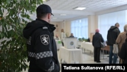 A policeman stands guard at a polling station in Chisinau during Moldova's presidential runoff on November 3. 