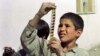 An Afghan boy examines a strip of film snatched from the flames of a bonfire lit by the Taliban to destroy cinema reels in Kabul in 1996.