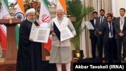 Indian Prime Minister Narendra Modi (R) and the Iranian President Hassan Rouhani releasing the commemorative stamp celebrating India-Iran relations at Hyderabad House in New Delhi on Saturday February 17, 2018.