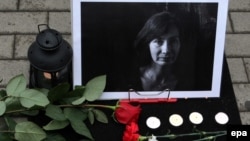 Flowers near the photo of slain journalist and human rights activist Natalya Estemirova in Moscow in August 2009