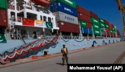 A Pakistani Navy soldier stands guard while a loaded Chinese ship prepares to depart from Gwadar Port. (file photo)