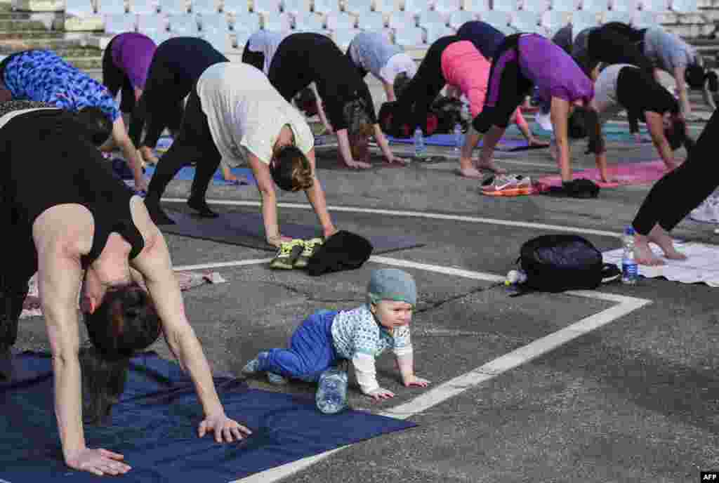 Yoga students and a baby take part in an outdoor yoga class at the Germia National Park in Pristina, Kosovo. (AFP/Armend Nimani)