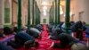 Uyghurs and other Muslims pray at a mosque in Kashgar in western China's Xinjiang Province, as seen during a government organized trip for foreign journalists on April 19. 