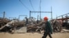 Работник возле объекта критической энергетической инфраструктуры, который был поражен во время ракетного удара России, Харьков, Украина, 10 апреля 2024 года