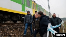 Polish Prime Minister Donald Tusk surveys the site of damaged railway tracks on the Warsaw-Lublin line on November 17 in Mika after an explosion that he called an "unprecedented act of sabotage."