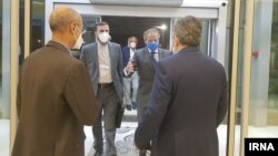 IAEA Director-General Rafael Grossi (in blue mask) arrives at Tehran's airport on September 11. 