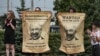 BELARUS -- Protesters hold the posters with Belarusian President Alyaksandr Lukashenka portraits standing near enter of the factory of refrigerators, freezers and washing machines Atlant and calling workers to join in strike and protests in Minsk, August 