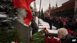 Communist Party supporters line up to place flowers at Stalin's grave near the Kremlin Wall to mark the 70th anniversary of his death in Red Square in Moscow on March 5.