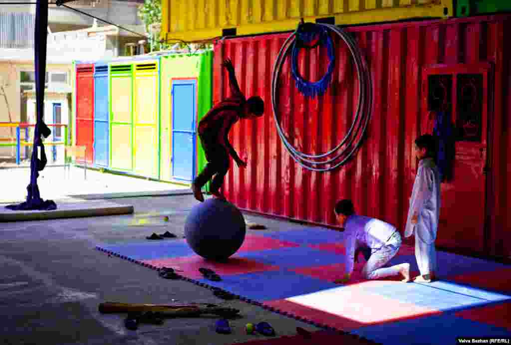 A child practices balancing on a ball. Students are taught acrobatics, tight rope, and juggling.