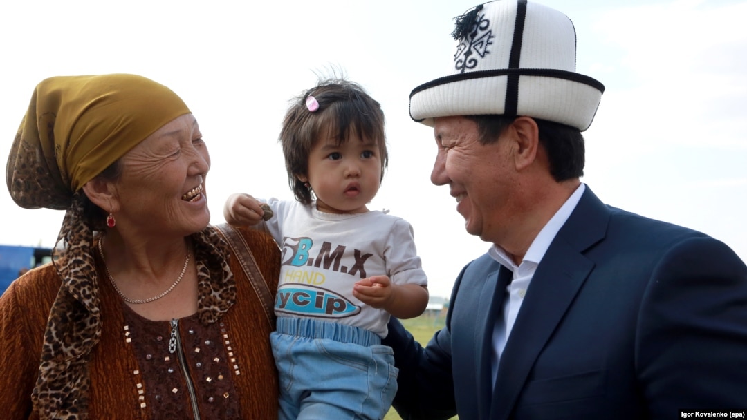 The leader of the Ak-Shumkar party, presidential candidate Temir Sariev (right), meets with local residents during his election campaign event in the village of Kun-tuu, near the capital of Bishkek, on September 11.