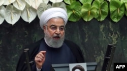 Iranian President Hassan Rohani delivers a speech during the inaugural session of the new parliament following February elections, in Tehran, May 27, 2020