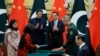 FILE: Pakistani Prime Minister Imran Khan (center L) and Chinese Premier Li Keqiang (centre R) applaud during a signing ceremony at the Great Hall of the People in Beijing on October 8.