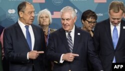 U.S. Secretary of State Rex Tillerson (center) shows the way out to Russian Foreign Minister Sergei Lavrov (left) after posing for a family photo at the Arctic Council meeting in Fairbanks, Alaska, on May 11.