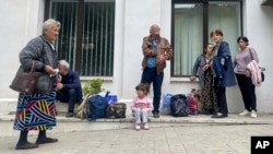 Local residents gather near a municipal government building after reports of shooting in Stepanakert, Nagorno-Karabakh, on September 21.