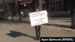 A Democratic Party supporter holds a single-person protest in Almaty on November 6.