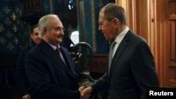 Libyan National Army commander Khalifa Haftar (left) shakes hands with Russian Foreign Minister Sergei Lavrov before talks in Moscow on January 13.