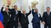 Russian President Vladimir Putin (center) cheers alongside Denis Pushilin, Leonid Pasechnik, Vladimir Saldo, and Yevgeny Balitsky, the respective Russian-installed administrators in Ukraine's Donetsk, Luhansk, Kherson, and Zaporizhzhya regions, at the September 30 signing ceremony.