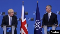 British Prime Minister Boris Johnson and NATO Secretary-General Jens Stoltenberg hold a joint news conference in Brussels on February 10. 