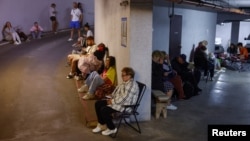 People take shelter inside an underground parking garage during Russian missile and drone strikes on Kyiv on July 6.