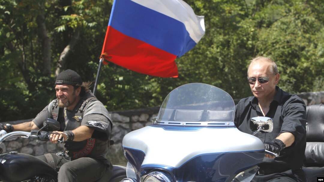 Russian Prime Minister Vladimir Putin (right) rides a Harley Davidson Lehman Trike as he arrives for a meeting with Russian and Ukrainian motorbikers at their camp near Sevastopol on July 24.