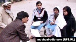 Khyber-Pakhtunkhwa Education Minister Sardar Babak (left) meeting with school girls