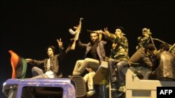 Rebel fighters in Benghazi celebrate the UN Security Council's resolution to impose a no-fly zone. 