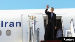 Iranian President Masud Pezeshkian waves before departing for New York, at Mehrabad Airport in Tehran on September 22.
