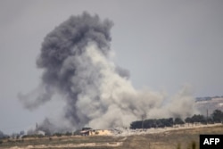 Smoke rises in southern Lebanon after an Israeli air strike on the village of Kfar Tibnit on May 30.