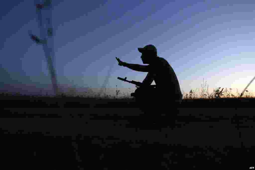 A soldier gestures while waiting by the position of Ukrainian forces in the Luhansk region. (AFP/Anatoly Stepanov)