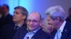 Freed Washington Post Tehran bureau chief Jason Rezaian (C) chats with US Secretary of State John Kerry during the inauguration of the Washington Post Headquarters on January 28, 2016 in Washington, DC.