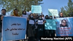 Afghan women hold banners and placards at a Kabul protest on September 8. 