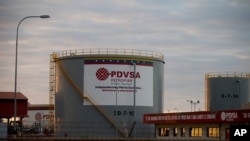 File photo: Feb. 18, 2015 photo, storage tanks stand in a PDVSA state-run oil company crude oil complex near El Tigre, a town located within Venezuela's Hugo Chavez oil belt, formally known as the Orinoco Belt. U.S. petroleum exports to Venezuela, much of