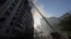 Firefighters work at the site of a Russian air strike on a residential building in Kharkiv on September 15. Ukrainian President Volodymyr Zelenskiy said at least 30 people were injured in the attack.