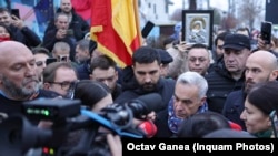 Calin Georgescu and dozens of his supporters gathered outside a closed polling station in Bucharest.