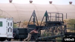 A U.S. soldier moves a maintenance stand at Karshi-Khanabad Air Base.