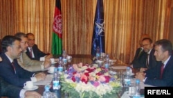 NATO chief Anders Fogh Rasmussen (right) during a visit with Afghan lawmakers in Kabul on August 7.