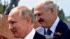 RUSSIA -- Russian President Vladimir Putin, left, and Belarusian President Alyaksandr Lukashenka greet WWII veterans during an opening ceremony of the monument in honour of the World War II Red Army, in the village of Khoroshevo, just outside Rzhev, June 