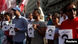 Members of the Awami Workers Party hold pictures with the name of student Mashal Khan during a demonstration in Karachi on April 18.